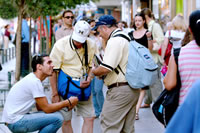 Two men pass out gospel materials in downtown Athens at the 2004 Games in Greece