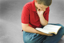 Child reading his Bible.